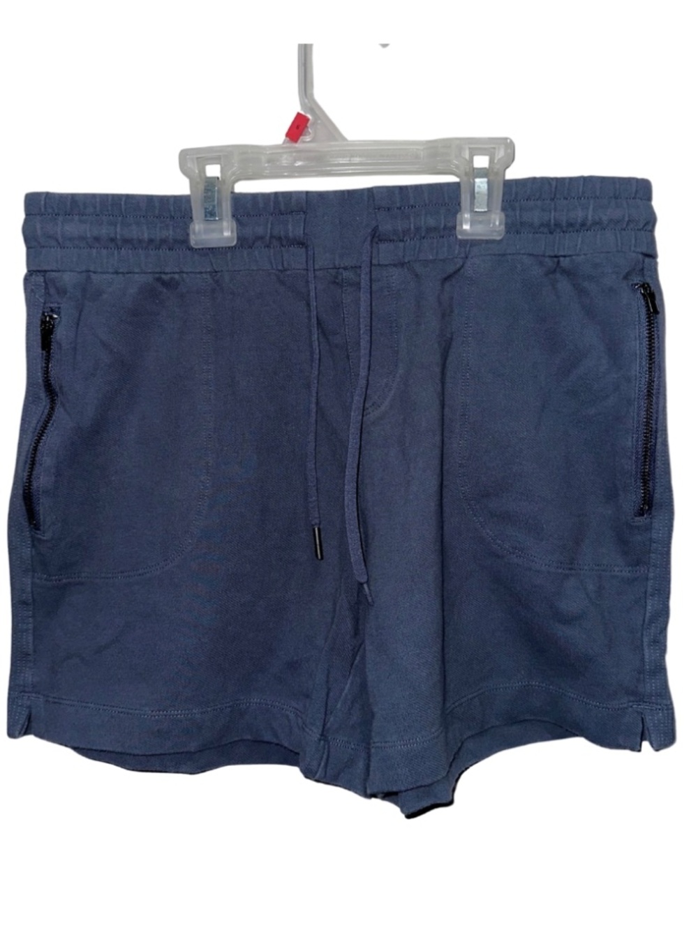 Blue athletic shorts with zipper pockets